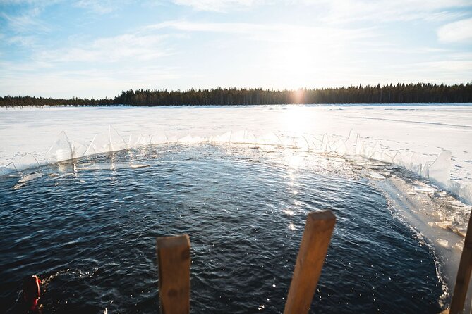 Daytime Arctic Ice-Floating in Rovaniemi, Small-Group - Entering the icy water