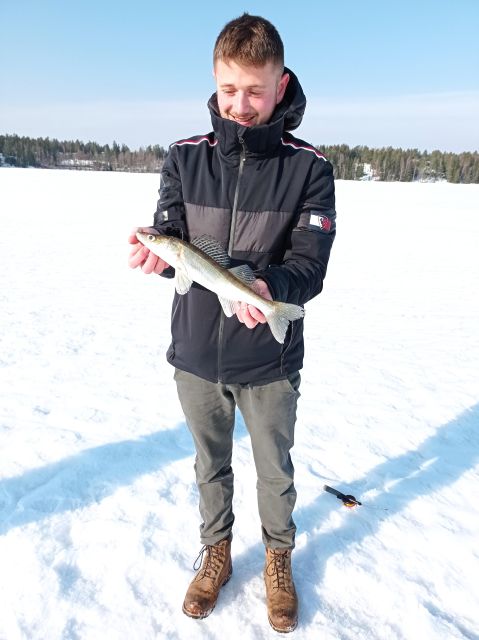 From Helsinki: Bodom Lake Ice Fishing with Food & Drinks - A campfire meal inside a Finnish laavu