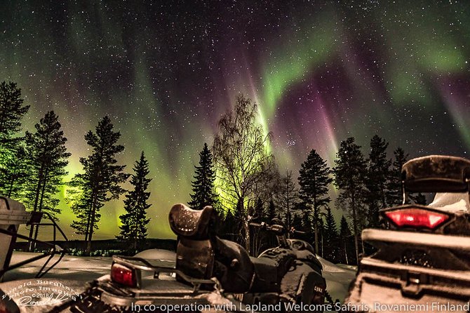 Hunting Northern Lights by Snowmobiles - Watching the sky from a dark northern horizon