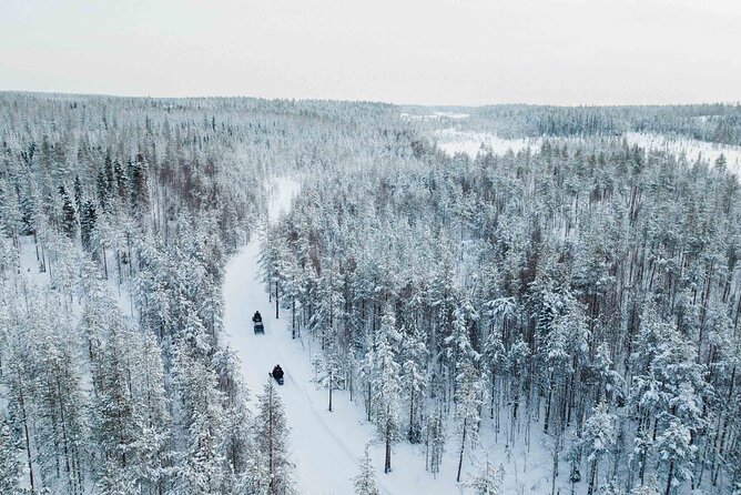 Ice Fishing and Snowmobile Safari Combo in Lapland - Drilling an ice hole and learning the local method