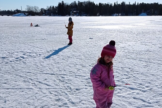 Ice fishing experience with Backpacker Helsinki Tour - Learning the ice fishing basics
