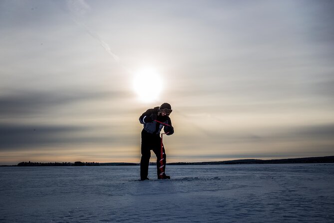 Ice Fishing on a Frozen Lake in Levi - Making the fishing hole