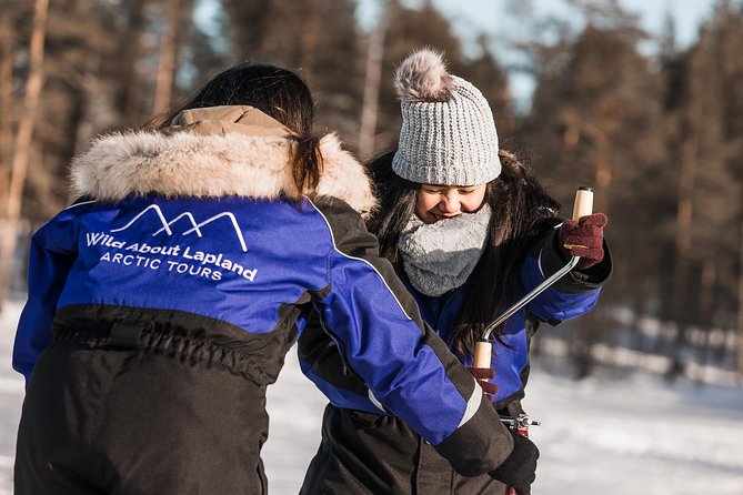 Ice Fishing Tour - Drilling through the ice is half the fun