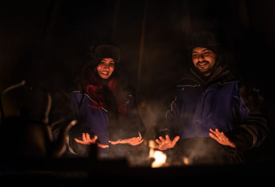 Ivalo: Lake Inari Northern Lights Tour w/ Reindeer & Dinner - Riding the covered sleigh across the frozen lake