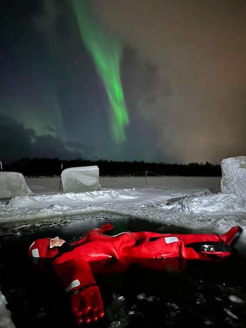 Rovaniemi: Ice Floating Experience with Northern lights - Getting into the water in a thermal wetsuit