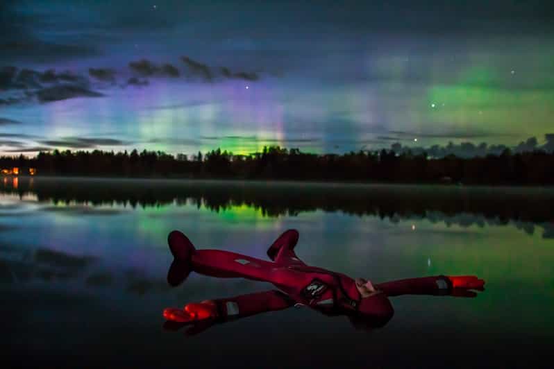 Ylläs: Northern Lights Ice-Floating Experience with Transfer - Warming up beside the campfire